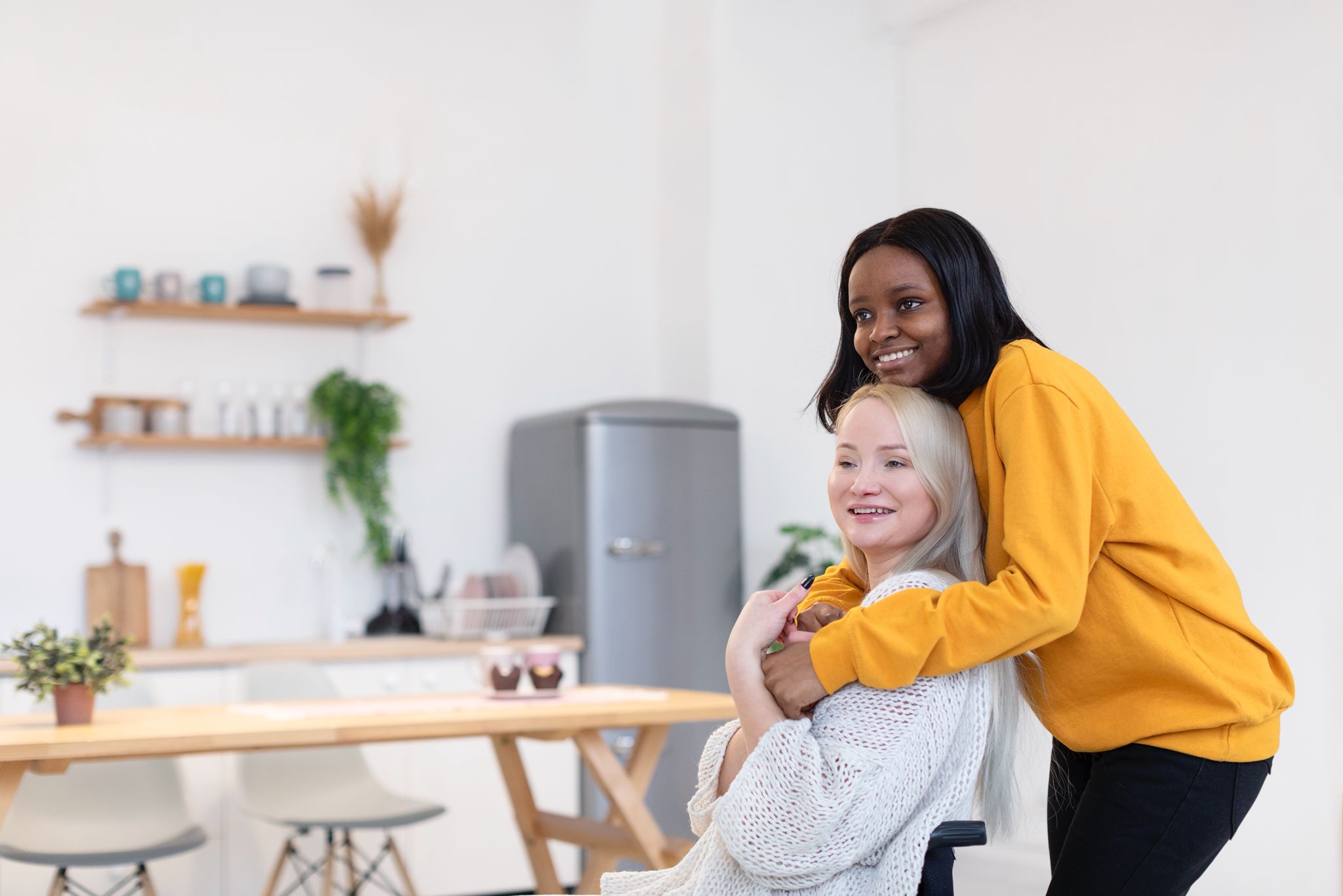 Two people sitting together at a kitchen table